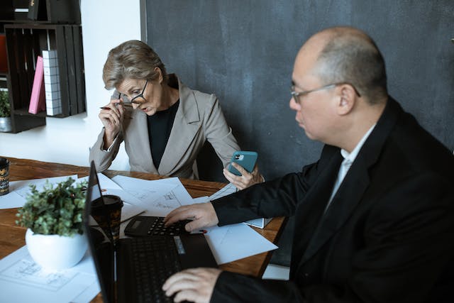 two property managers looking over reports while sitting at a conference table